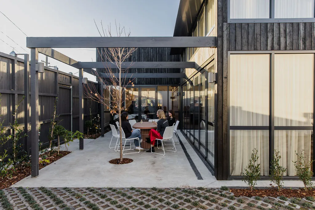 Outdoor courtyard at The Retreat Geelong with custom steel pergola and large T-bar windows by Geelong Steel Fabrication